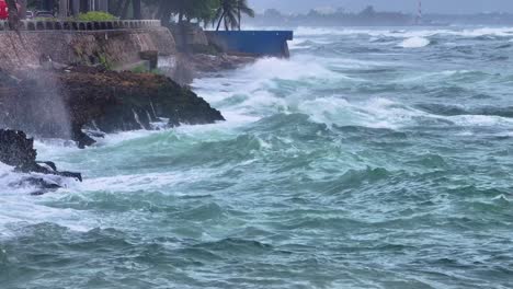 Aerial-view-showing-large-waves-of-ocean-crashing-against-rocky-coastline-on-Dominican-Republic-Island