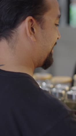 a man looking at jars