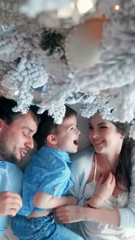 happy family underneath the christmas tree