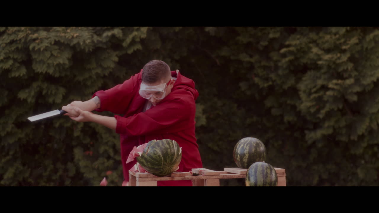 Man Chopping Watermelons with a Knife