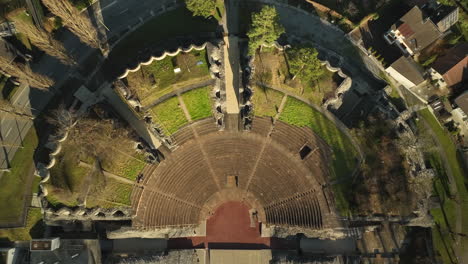 people walking in the roman theater augusta raurica top down drone lifting shot