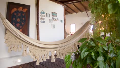 beautiful hand woven beige hammock hanging to relax on tropical lodge, dolly in