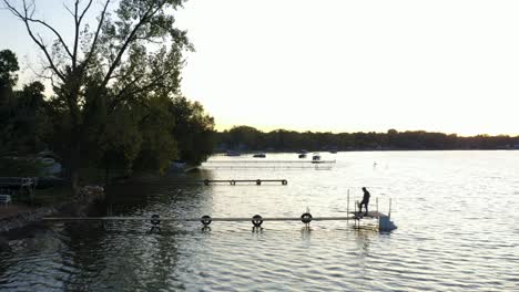 Drohnenaufnahme-Eines-Sees-Mit-Docks-Bei-Sonnenaufgang