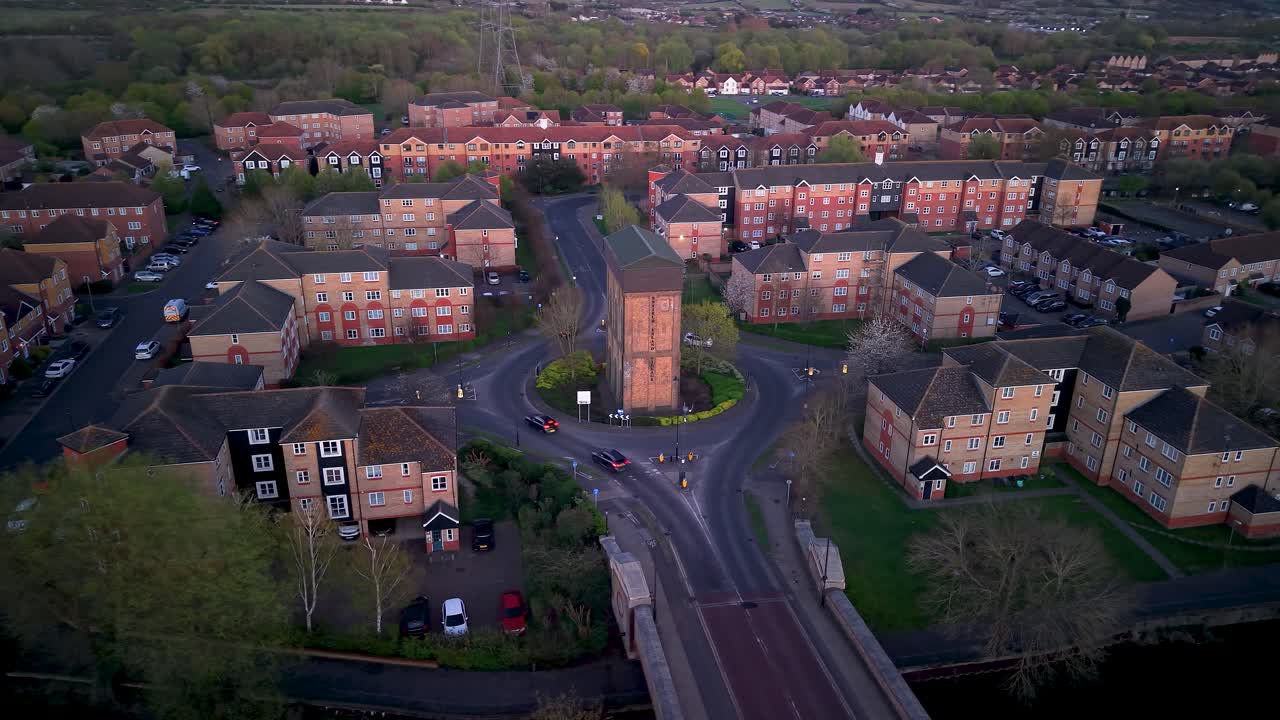 Enfield island water tower aerial view with traffic driving round roundabout modern housing village