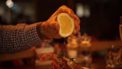 SLOWMO---Squeezing-a-lemon-on-a-boiled-New-Zealand-crayfish-in-a-luxury-restaurant---CLOSE-UP