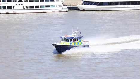 police boat speeding on the river thames