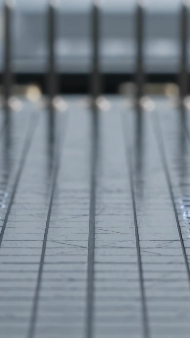 Vertical video: Shifting camera revealing grooved walkway on platform, exposing right tactile strip