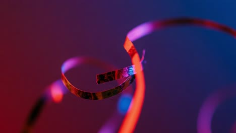 delicate swirls of colorful streamers captured in motion against a dark background, exuding a vibrant and playful essence of celebration and festivity