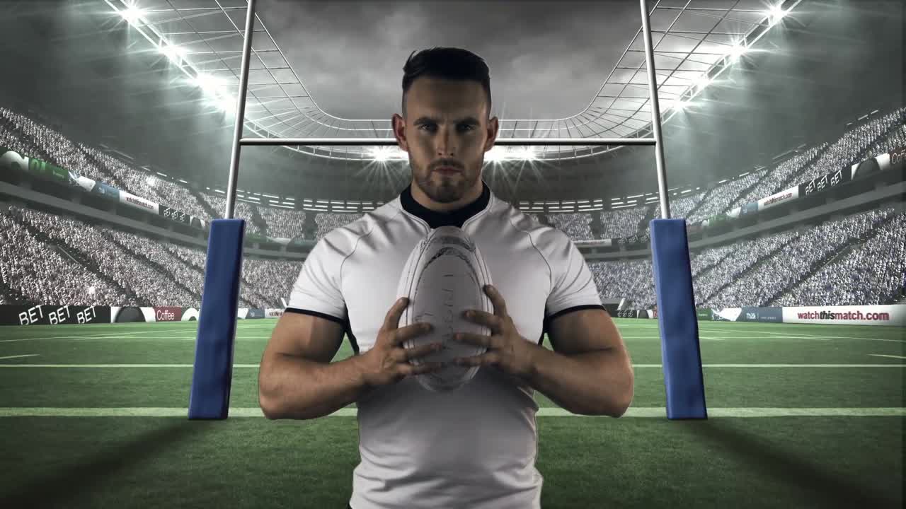 jugador de rugby serio sosteniendo una pelota de rugby