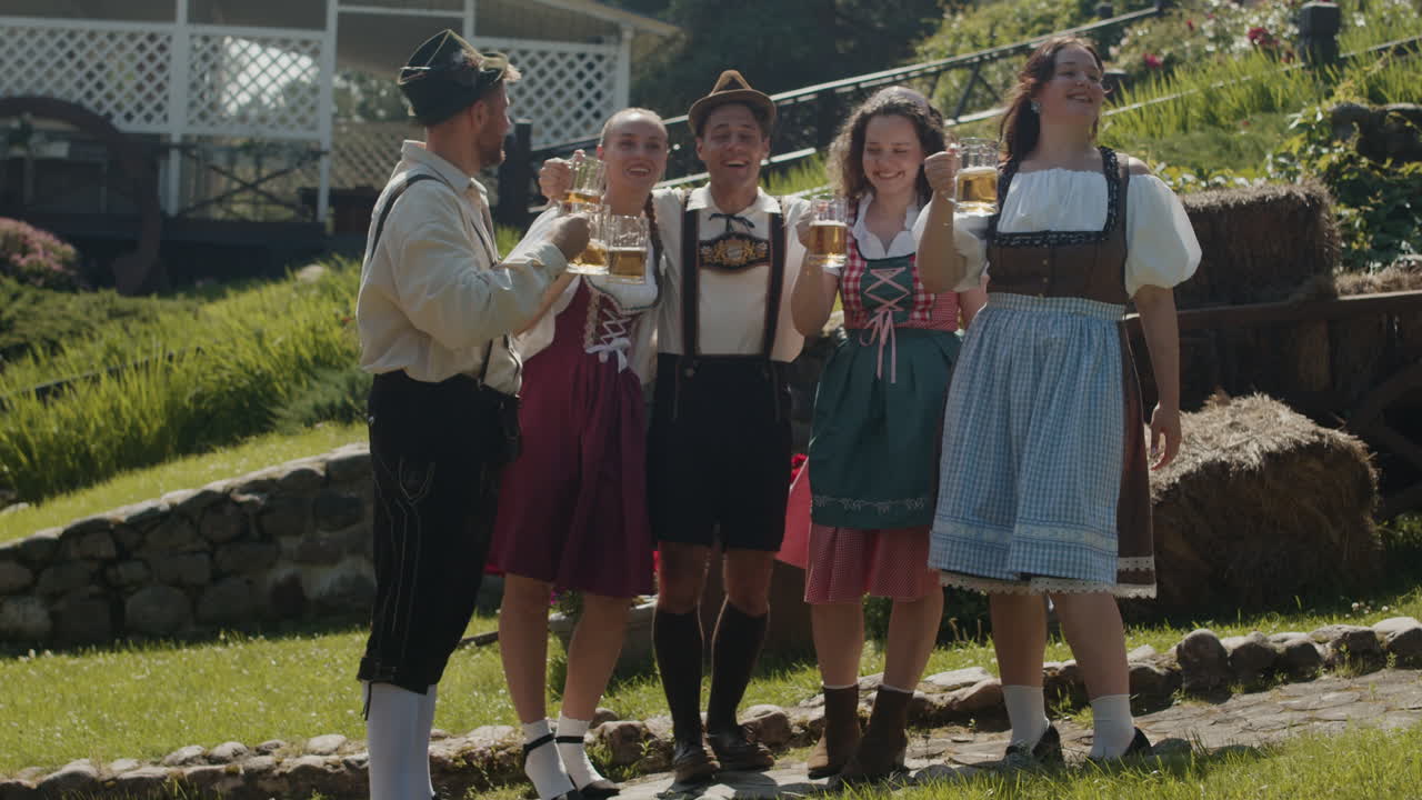 Group of people in traditional German clothing celebrating Oktoberfest with beer