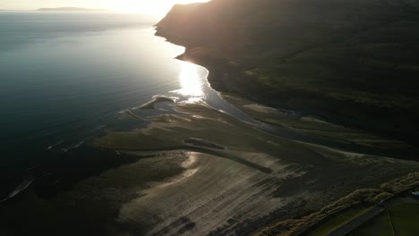 Flying-down-to-gravel-beach-with-high-reflections-at-Glenbrittle-Isle-of-Skye-Scotland