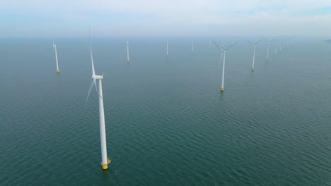 huge windmill turbines, offshore windmill farm in the ocean westermeerwind park , windmills isolated at sea on a beautiful bright day netherlands flevoland noordoostpolder