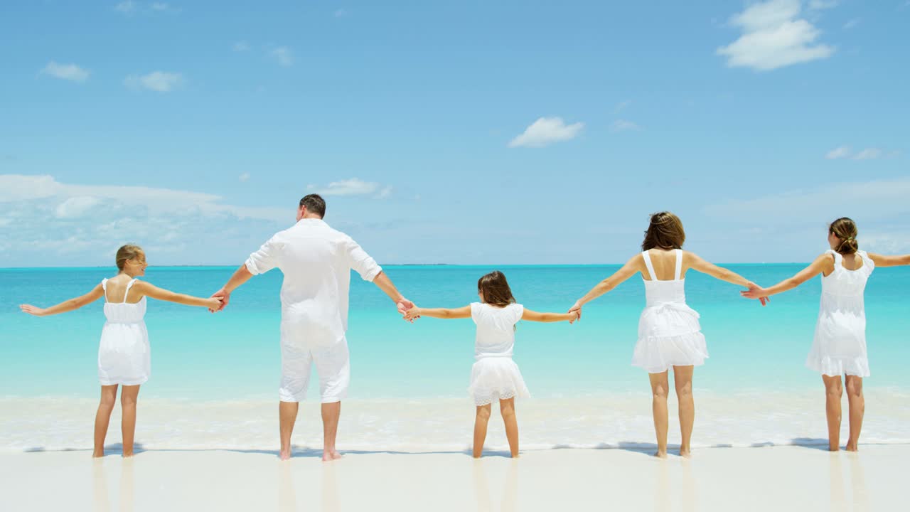 사랑하는 백인 가족이 열대 해변에서 재미를 느끼고 있습니다.