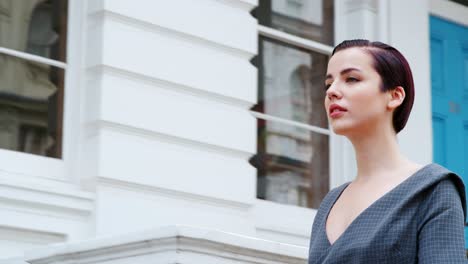 Stylish-Woman-Carrying-Bag-Walks-Along-City-Street