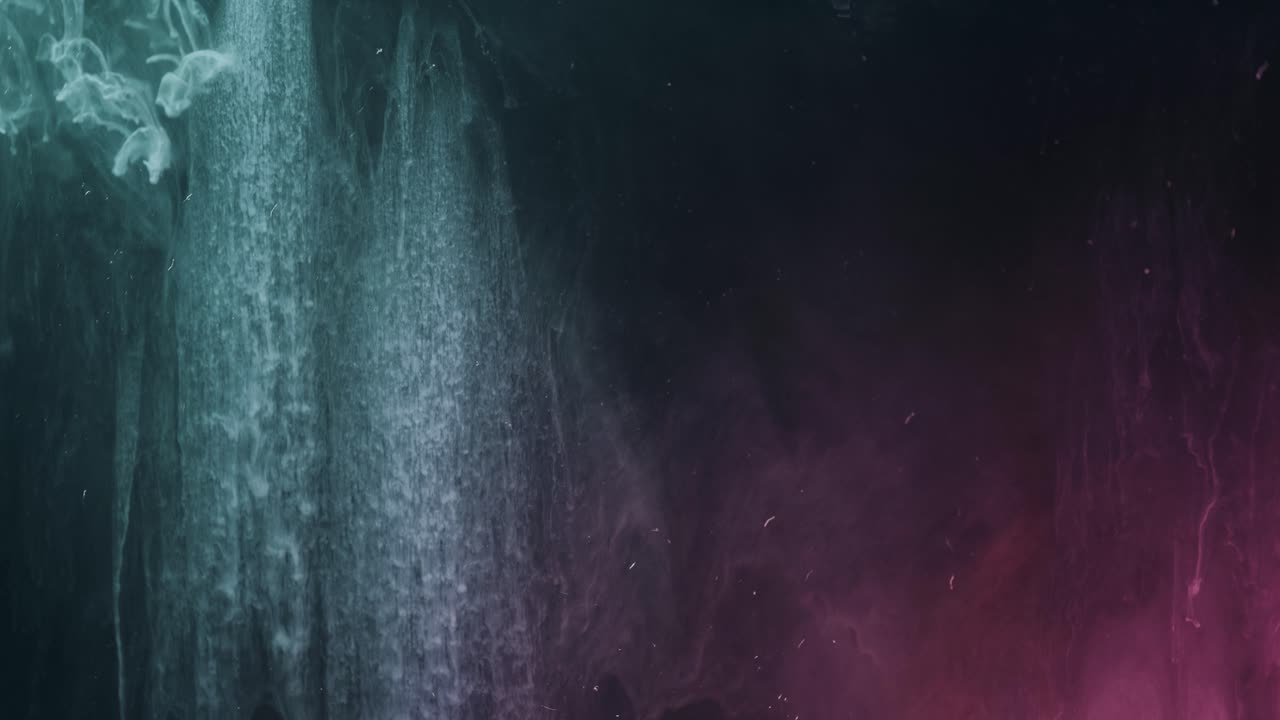 Swirling paint ink underwater in front of black screen - Slow motion explosion effect - Peaceful wallpaper