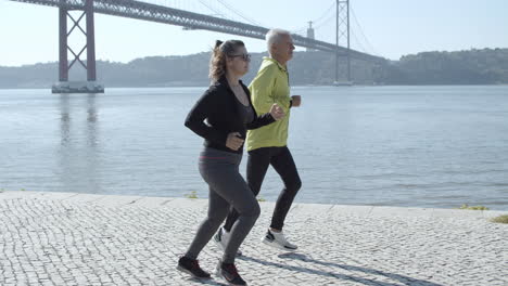 active runners training together near water in sunny day