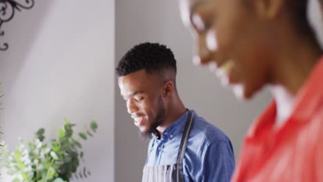 happy african american couple preparing meal in kitchen