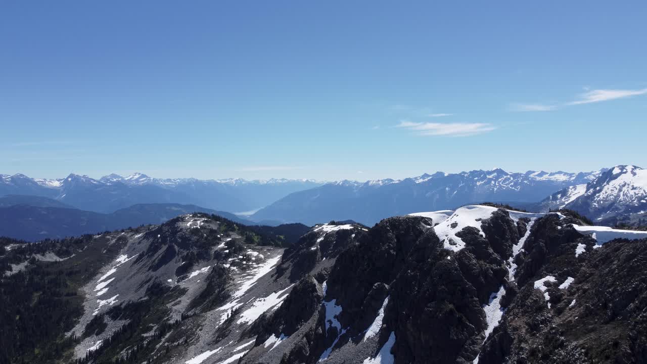 Mountain Landscape Elegant Slow Rising Reveal Aerial Drone with Bright Blue Sky and Snow Pacific Ranges Canada 4K
