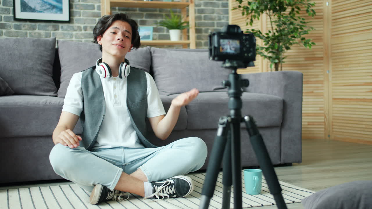 Teenager vlogger recording a video at home