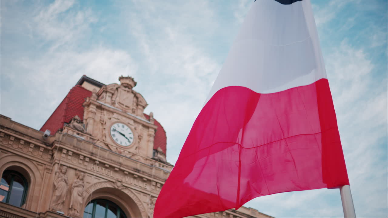 French flag waving in front of the Mairie de Cannes Town hall in Cannes, France