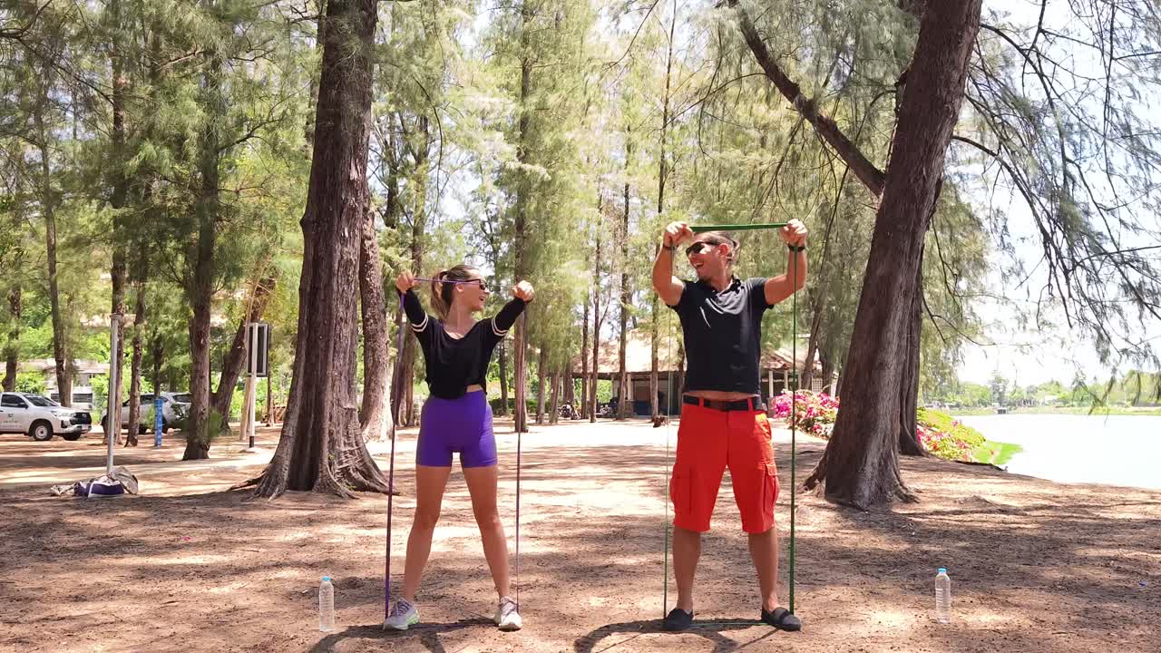 Couple Exercising Outdoors with Resistance Bands