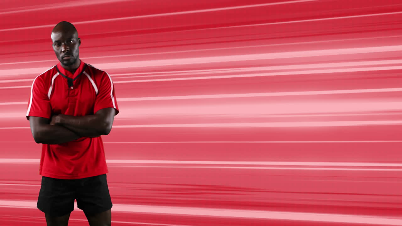 Animation of rugby player standing with arms crossed over glowing red light trails background