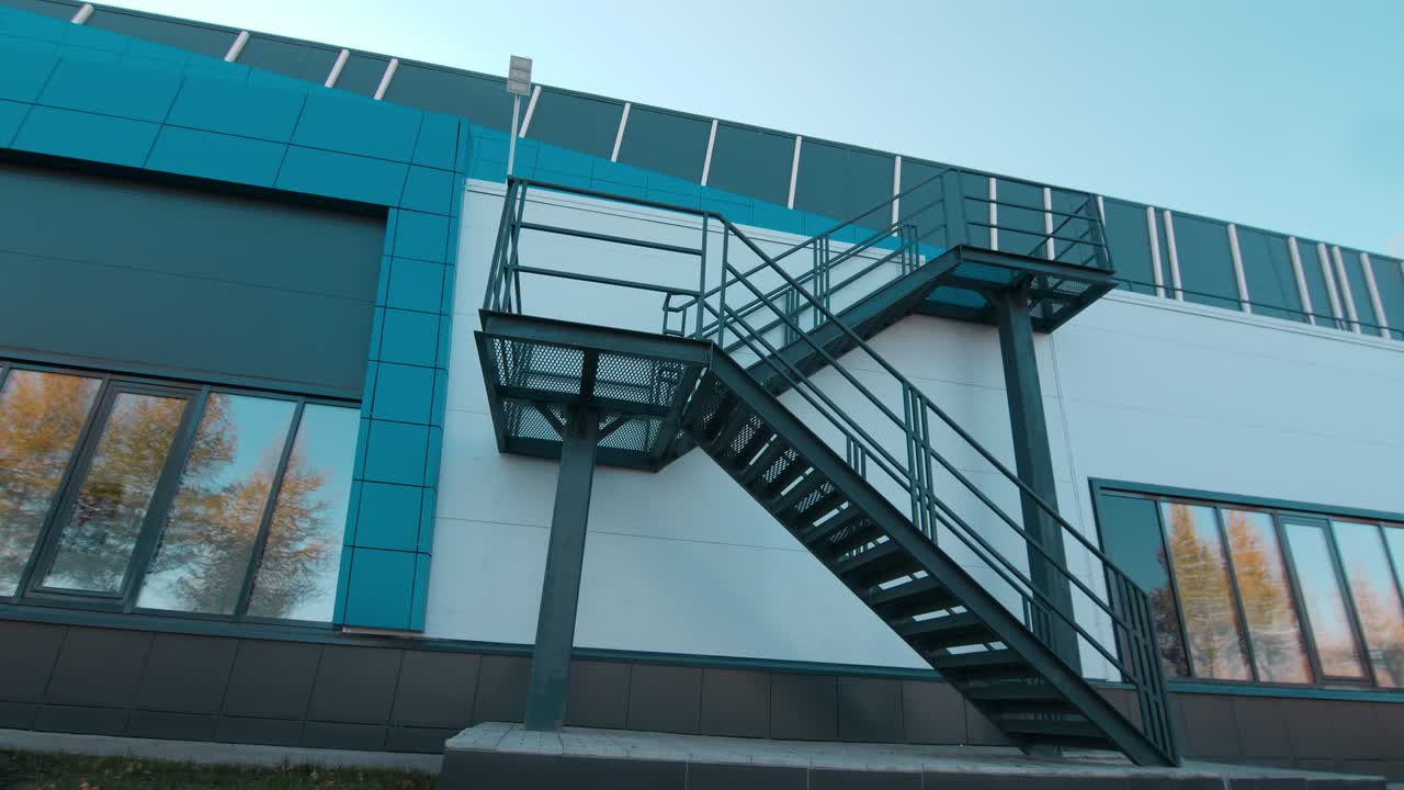 Metal staircases on wall of stylish building on city street