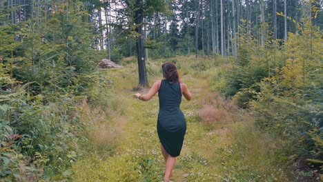 pretty woman dancing in a forest in slow motion