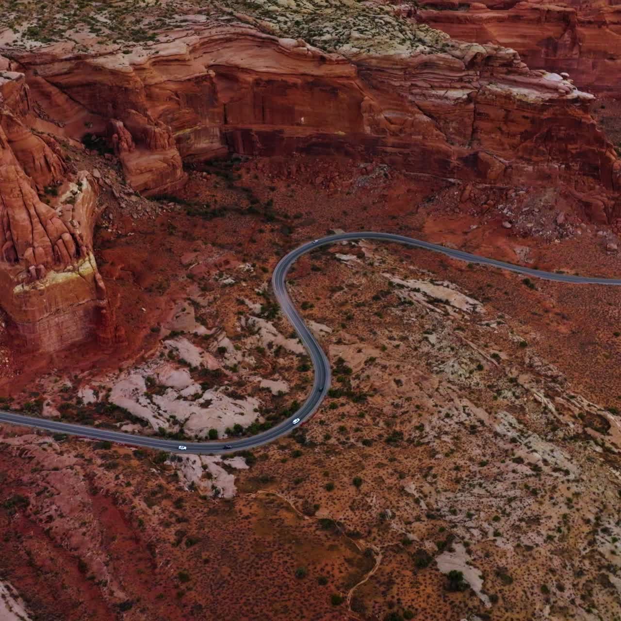 Red huge rocks of Zion National Park in Utah, USA. Wavy road circling the gorgeous mountains. Aerial view