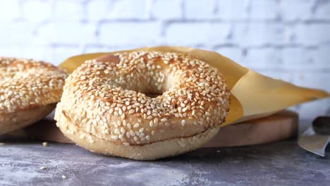 fresh bagel bread in a paper on table