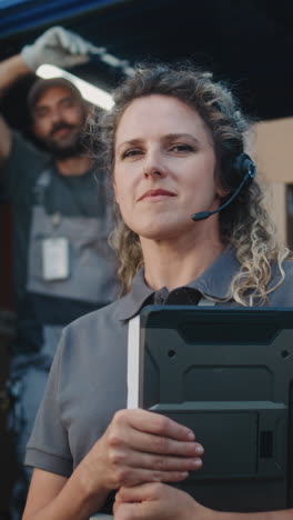 a woman wearing a headset and holding a tablet