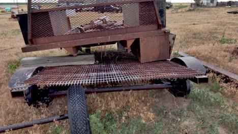 a rusty old piece of equipment decomposes in a field