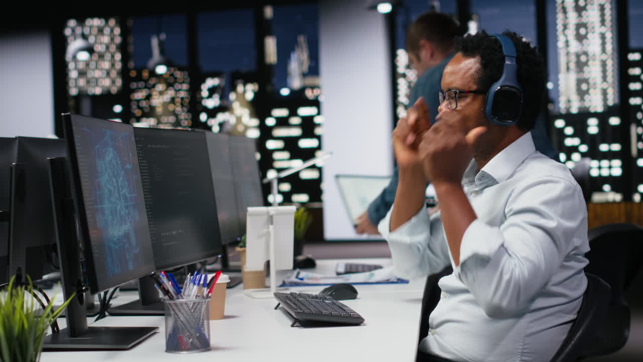 African American Programmer Working on Computer in Modern Office at Night