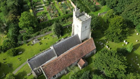 a slow arc-shot orbiting around holy cross church in goodnestone