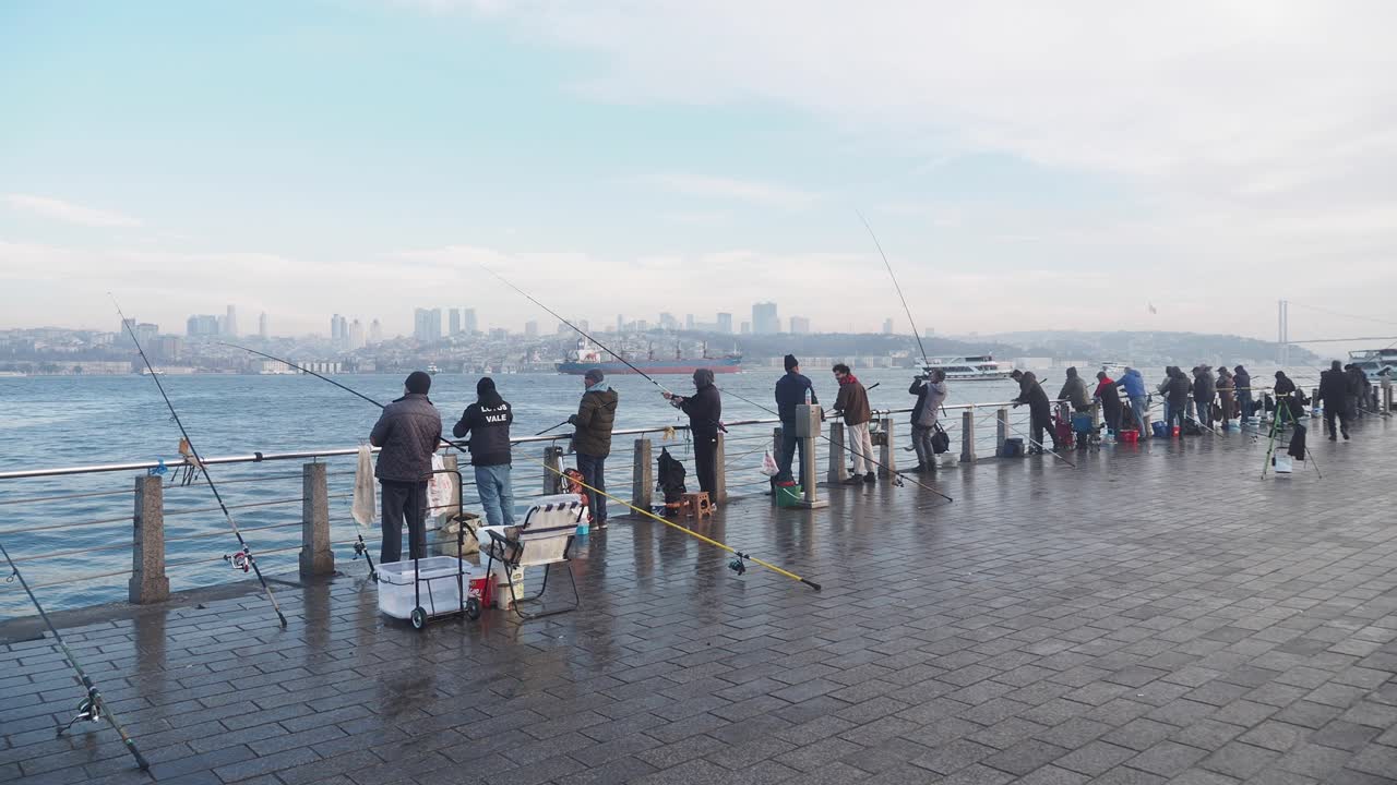 People fishing on Istanbul waterfront pier in winter