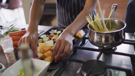 video of hands of biracial woman preparing meal