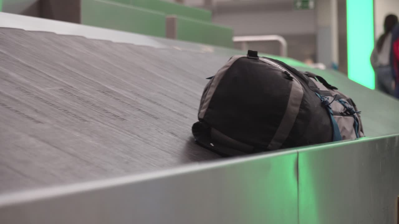 Backpack or luggage on conveyor belt at airport, baggage claim concept