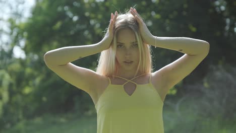 woman in yellow dress dancing gracefully in summer park