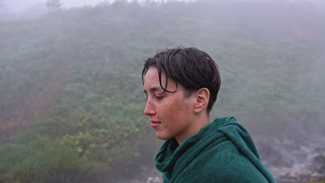 teenager in a towel in the foggy forest