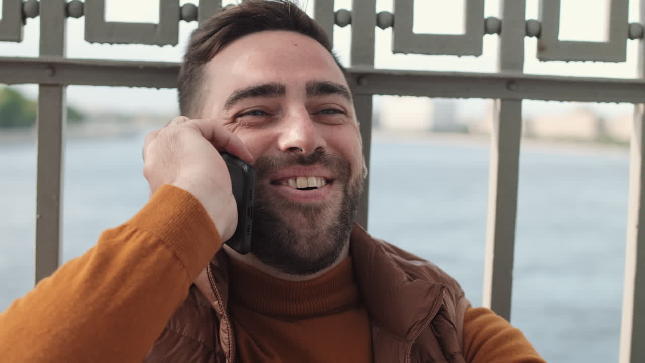 Happy Man Talking on Phone Outdoors