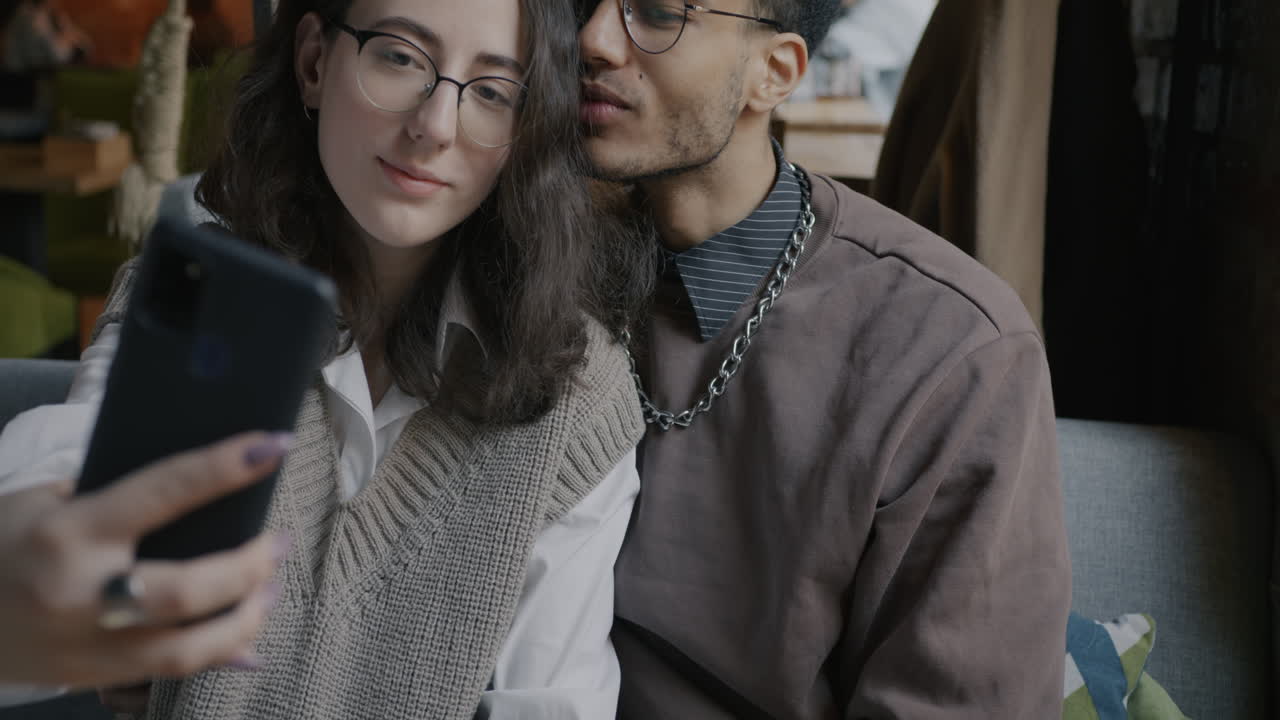 Couple taking a selfie in a cafe