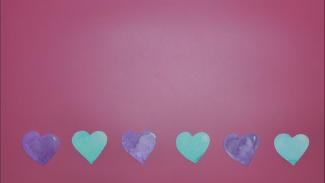 detención del movimiento de bucle sin costuras papel cortado acuarela pintado a mano corazones coloridos cambiando de color en el borde horizontal en fondo rosa para el día de san valentín