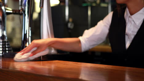 bartender in uniform cleaning