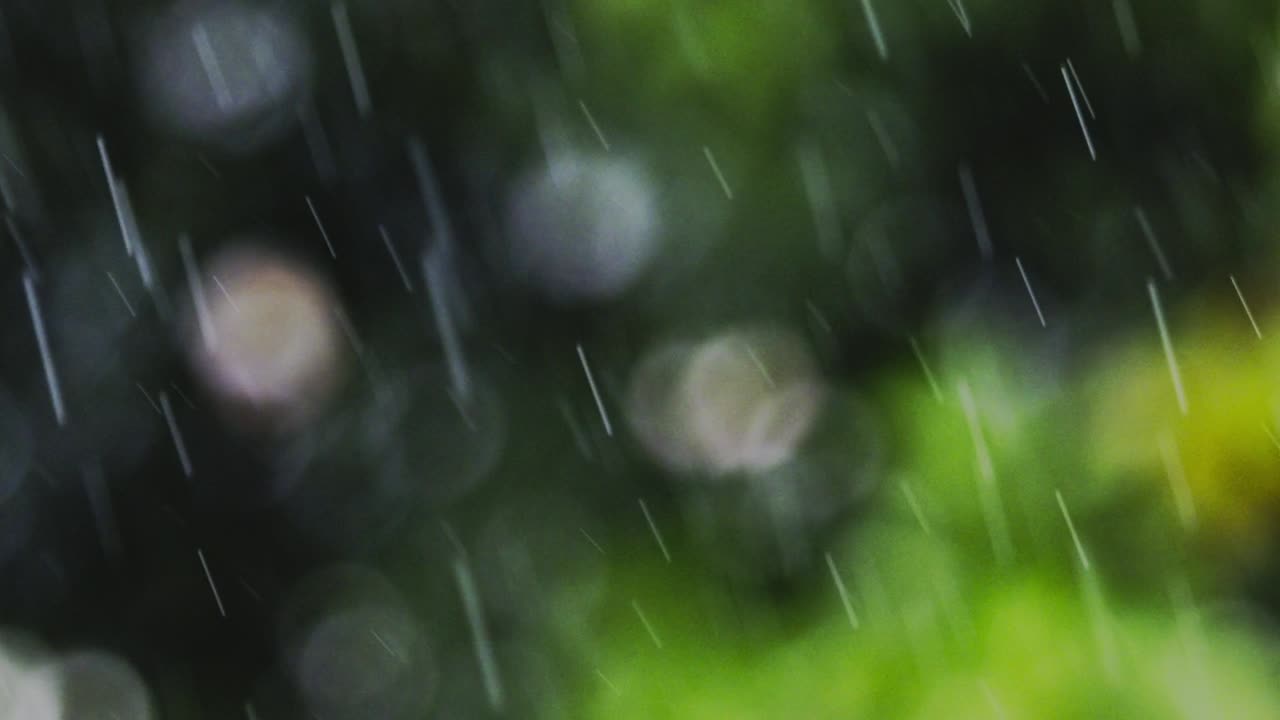 Intense rainfall transforms the scene into blurred veil of cascading water