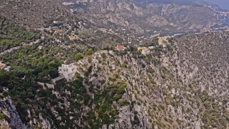 Villefranche-sur-Mer-France-Aerial-v1-breathtaking-landscape-view,-drone-flying-along-the-rock-ridges-cliff-capturing-secluded-houses-located-on-clifftop---July-2021