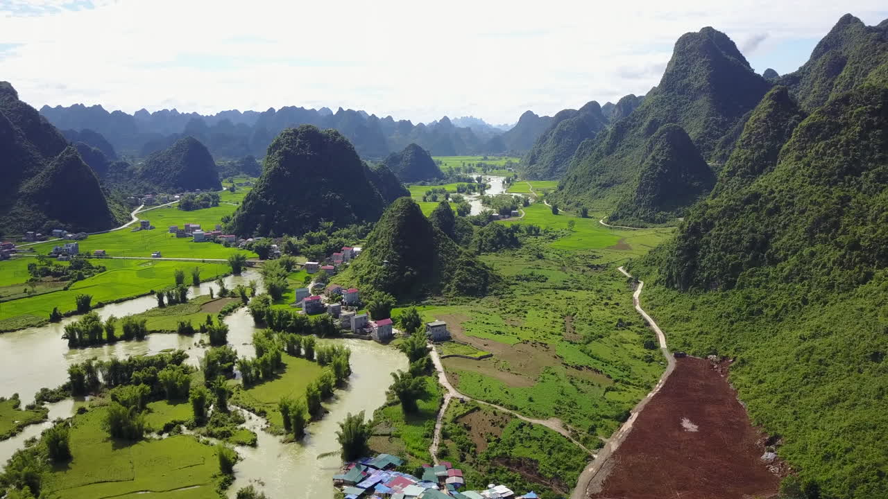 Aerial view of lush Ban Gioc Waterfalls and green landscape in daylight