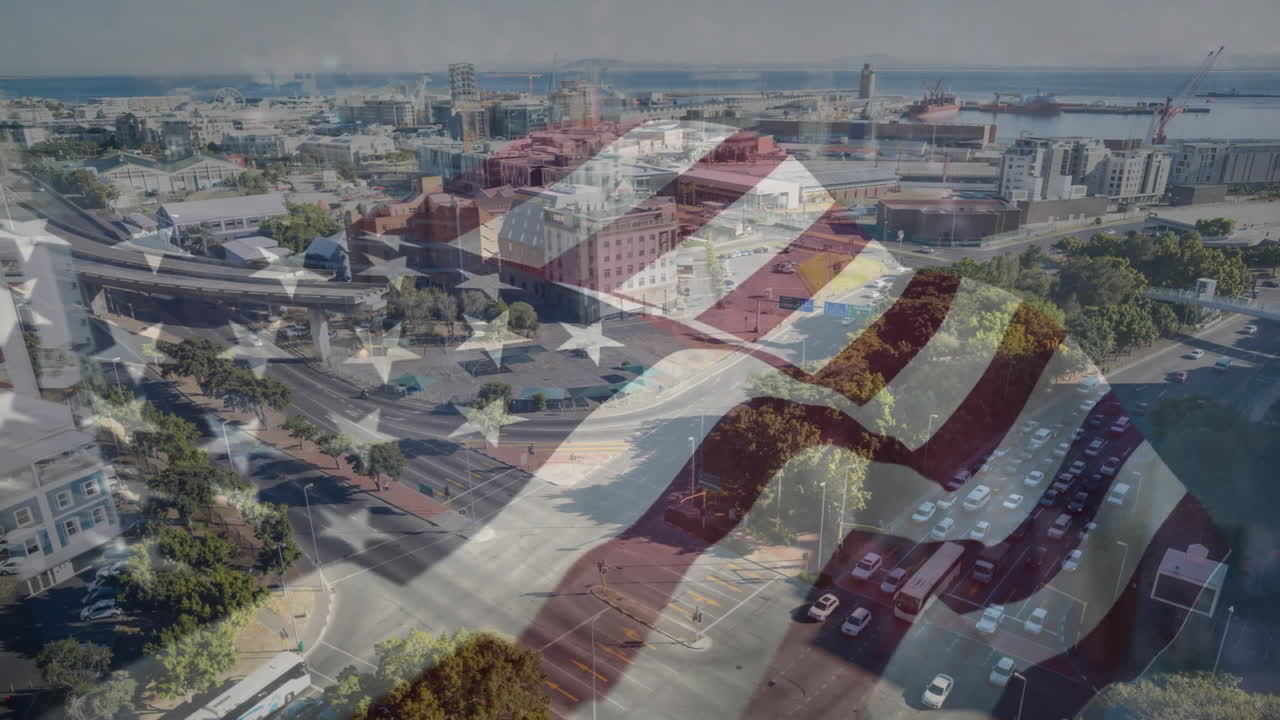 American flag animation over aerial view of urban cityscape with roads and buildings