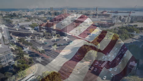 american flag animation over aerial view of urban cityscape with roads and buildings