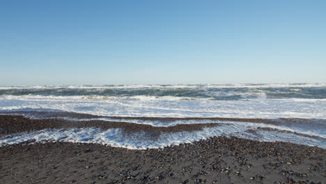 wavy beach waters in denmark