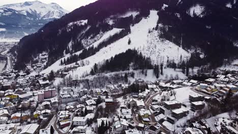 ski slope and townscape of austrian town of zell am see, aerial establishing